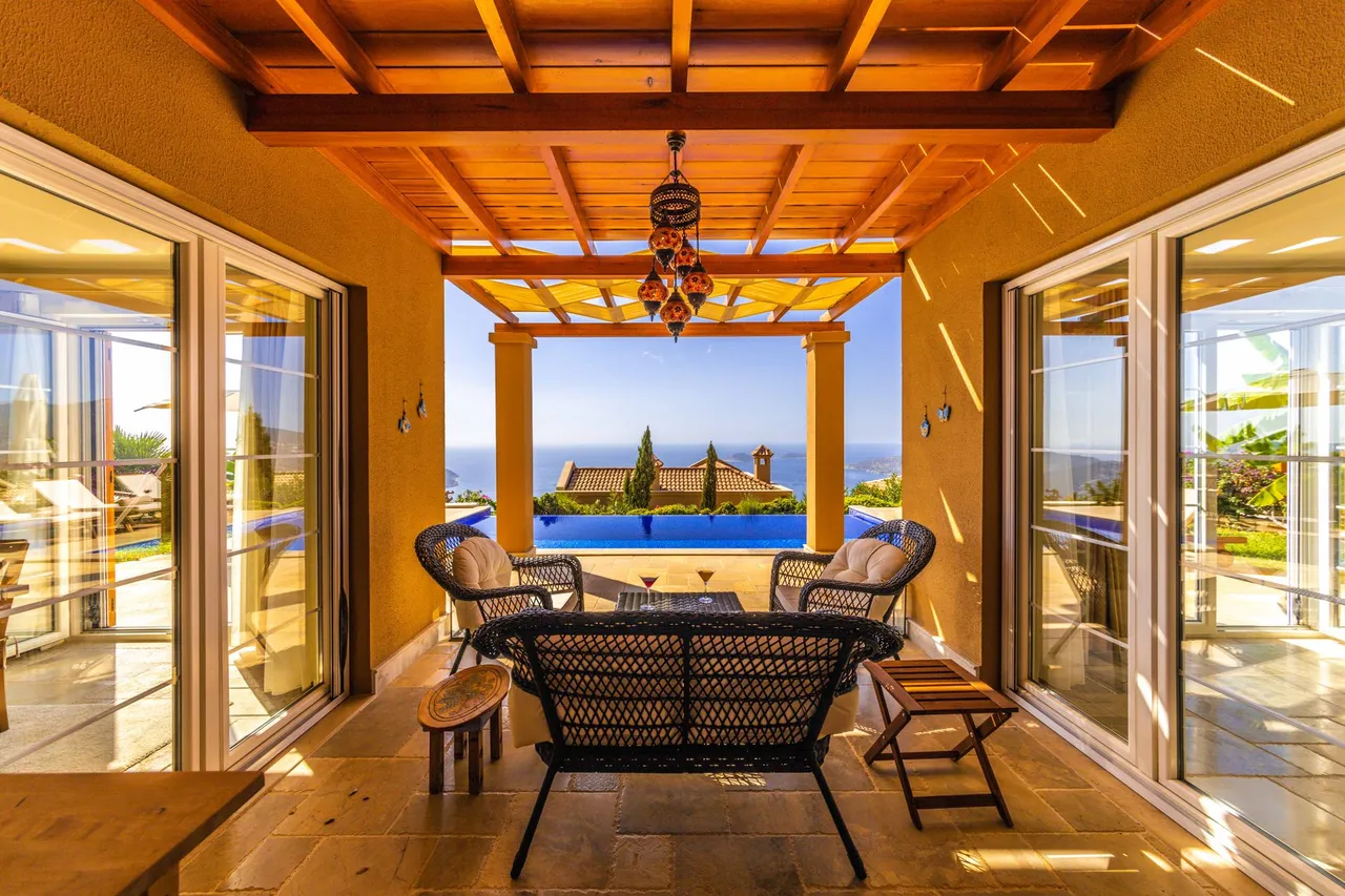Terrasse einer mediterranen Villa mit Meerblick zur goldenen Stunde